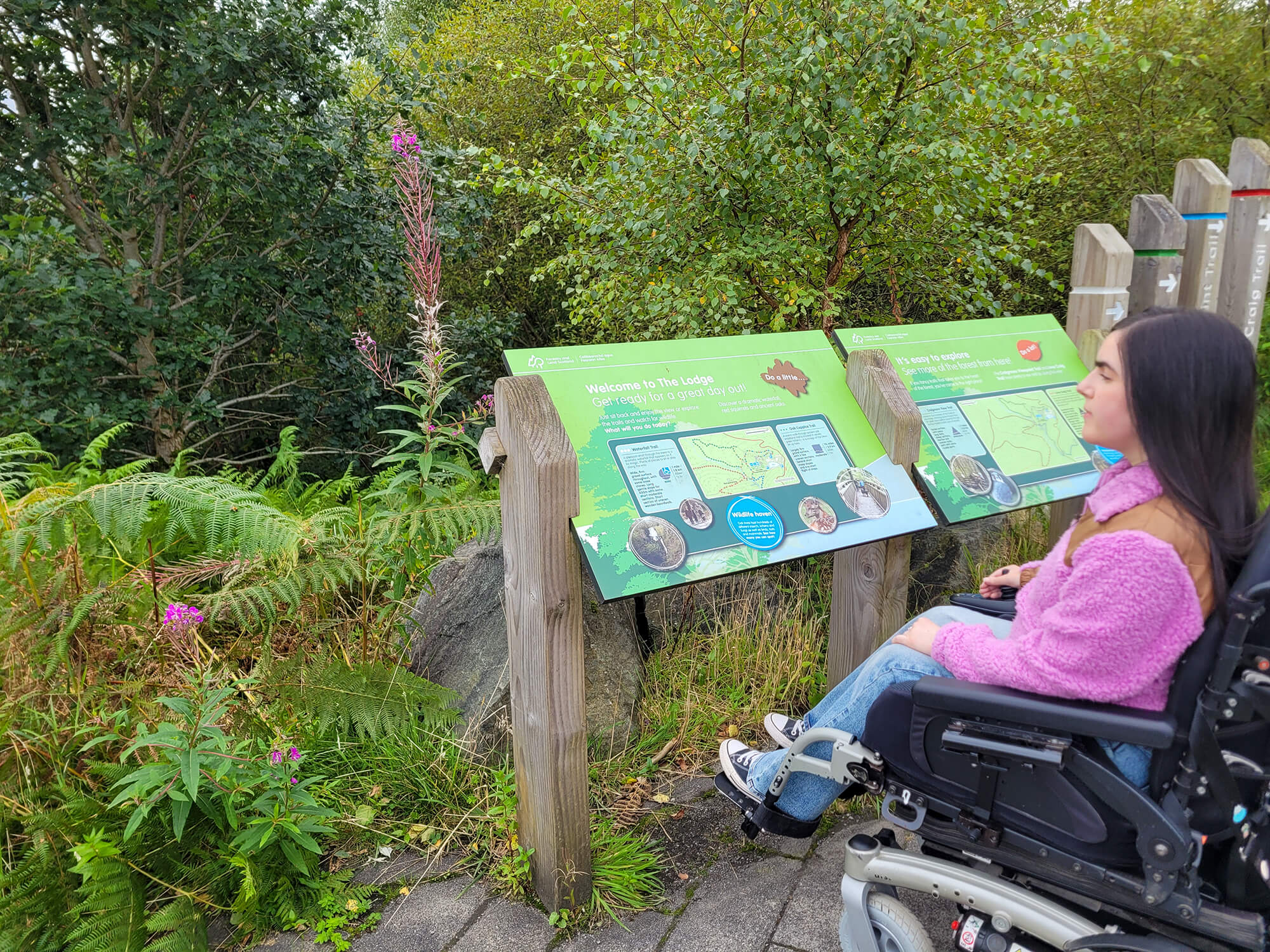 Emma looking at the Waterfall Trail map at The Lodge, Aberfoyle.