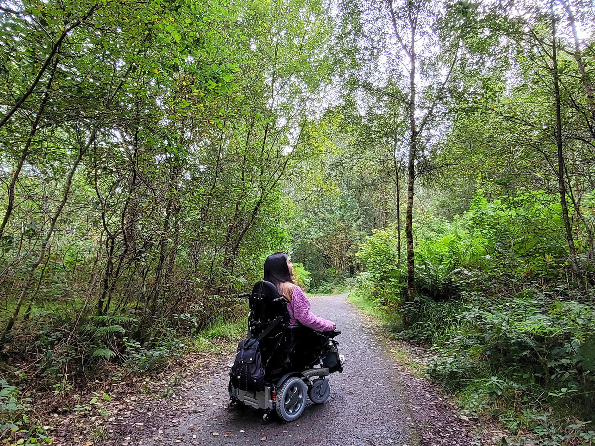 Emma viewed from behind as she navigates the Waterfall Trail in Queen Elizabeth Forest Park at The Lodge, Aberfoyle.