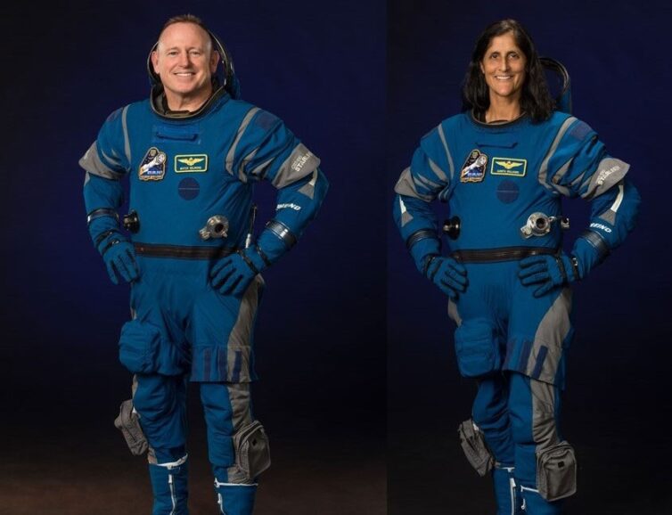 Astronauts posing in their flight suits