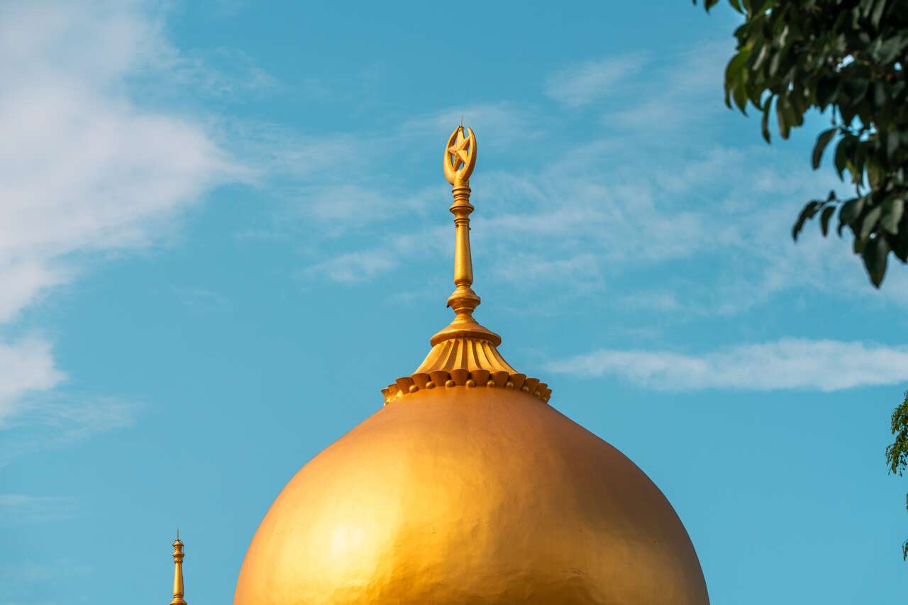 A yellow dome mosque on a clear day in Singapore