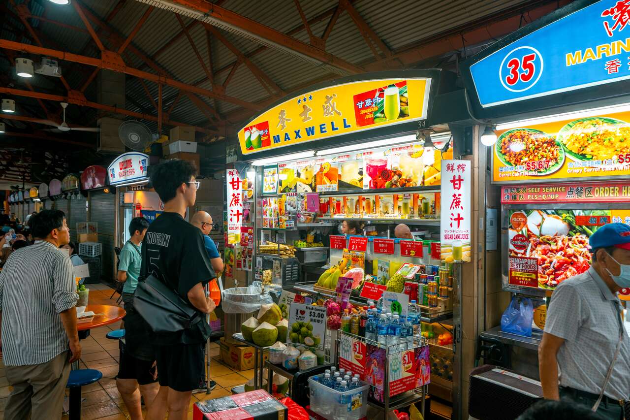 People buying food at a hawker market in Singapore