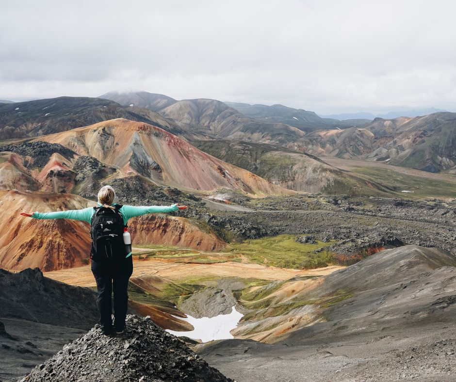 Jeannie with her rain gear admiring the stunning landscape view of Iceland's Highlands | Iceland with a View