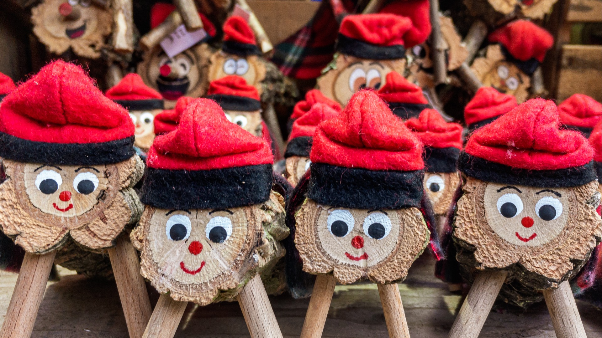 A close-up of Tio de Nadal toys with smiling faces and red hats.