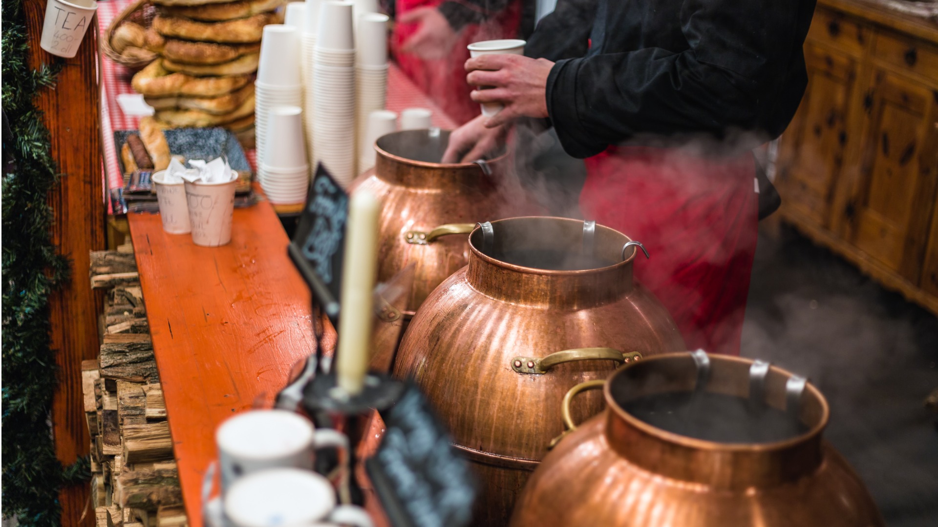 A vendor serving mulled wine at a Budapest Christmas market.