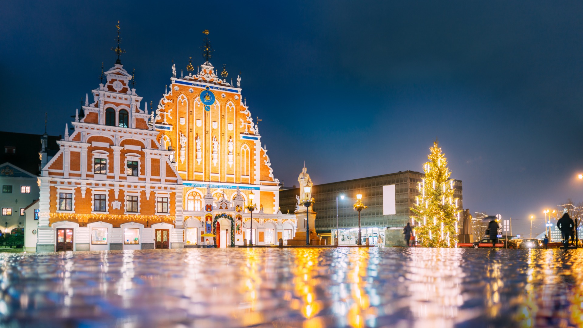 The charming Riga Town Square adorned with festive decorations and a Christmas tree.