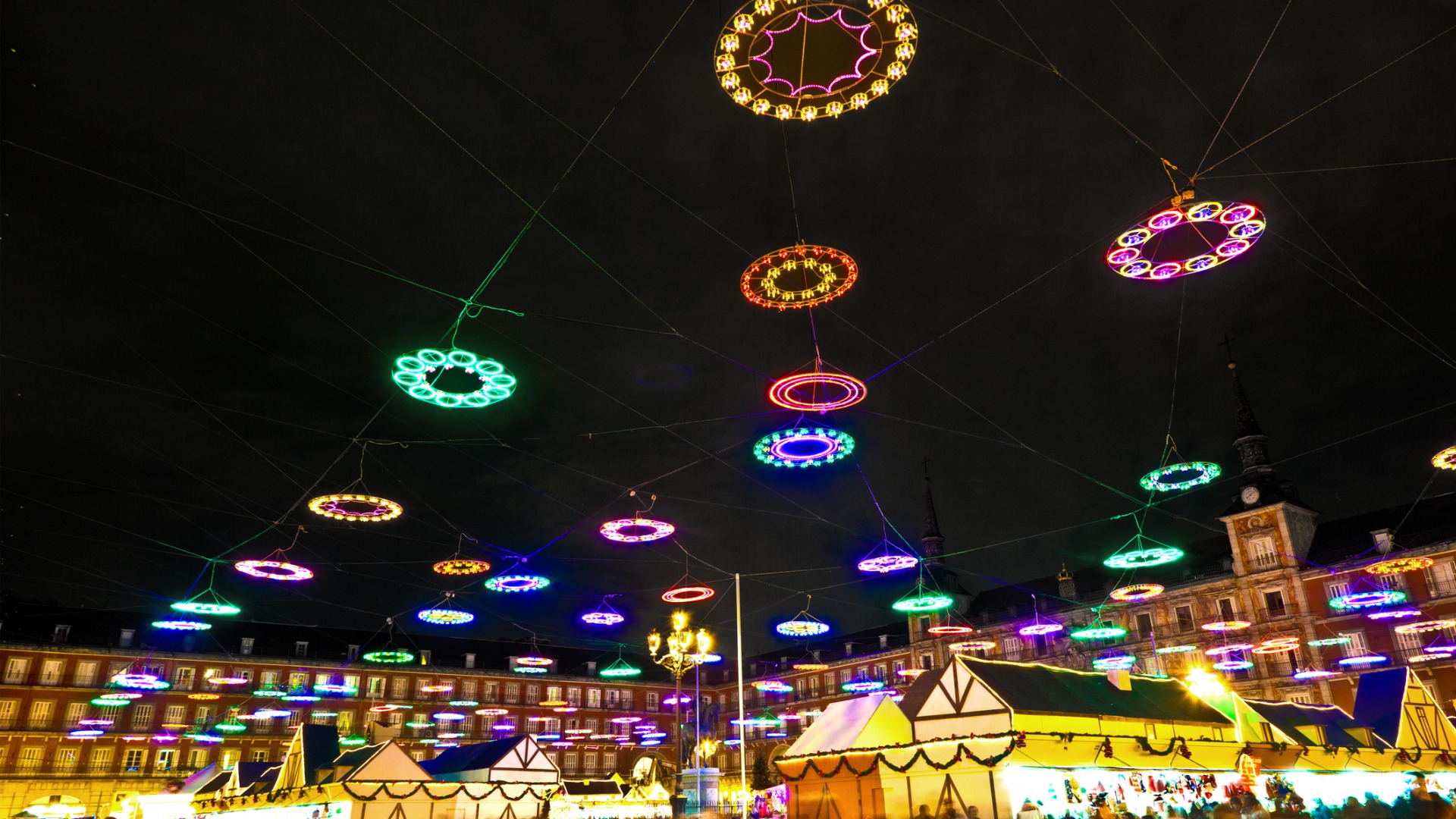 The festive lights glistening over the stalls in Madrid's Plaza Mayor Christmas market.