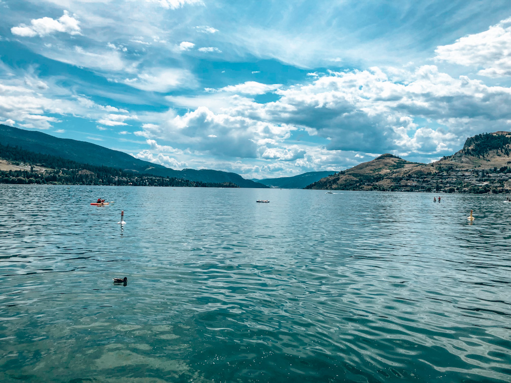 Explore the finest beaches in Okanagan Valley. Top beaches in Kelowna, Penticton, Peachland on Okanagan Lake, and more at Kalamalka Lake and Skaha Lake await you. Experience the best Okanagan beaches this summer! #explorebc #hellobc #bcparks #osoyoosbc #exploreokanagan #bcbeaches #explorecanada #okanagan