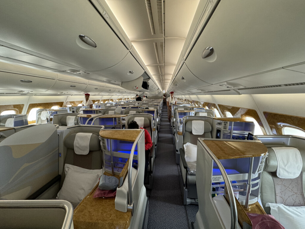 inside an airplane with seats and people sitting on it