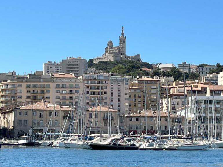 Basilica of Notre Dame on a hilltop of Marseille seen from the old port, France