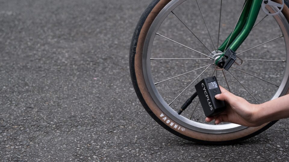 bike wheel and hand with bike pump in action