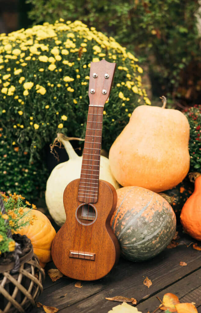 Explore fun activities to do in Hawaii in October. Image features an ukulele and pumpkins