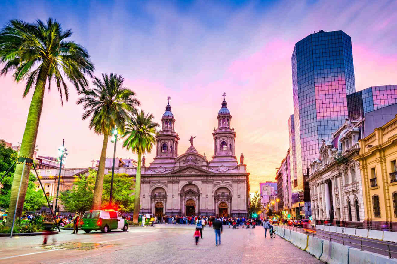 Plaza de Armas in Santiago, Chile, at dusk showcasing the Metropolitan Cathedral and surrounding palm trees against a vibrant sunset sky