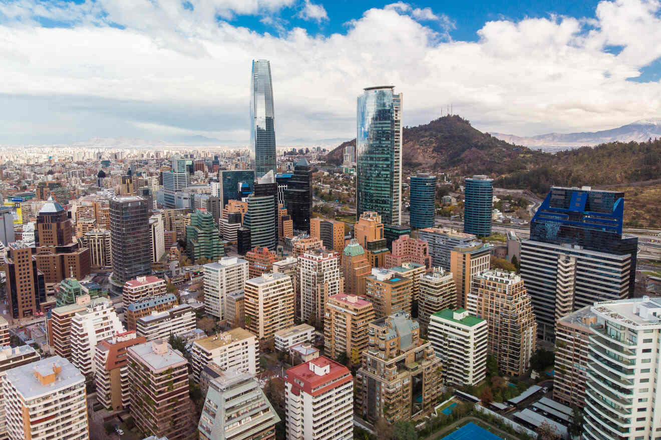 Aerial view of Santiago de Chile's business district, showcasing tall glass skyscrapers and the surrounding urban landscape.