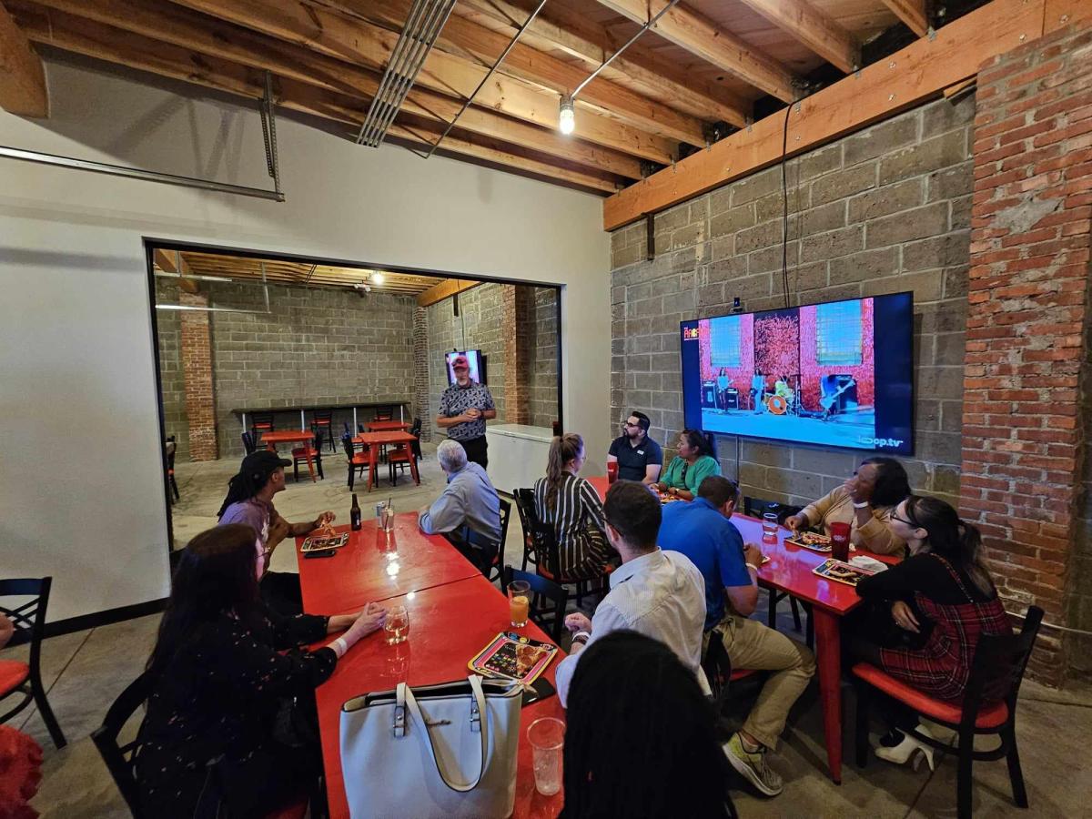 People gather in the private dining room at The Arcade