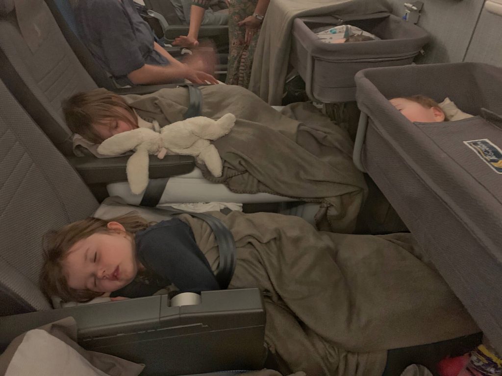 Kids asleep on Flyaway mattress and Plane Pal. Which is the best travel bed? Flyaway vs Plane Pal Travel Bed