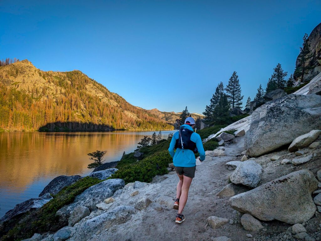 A woman trail running near Echo Lake, California on a summer day.