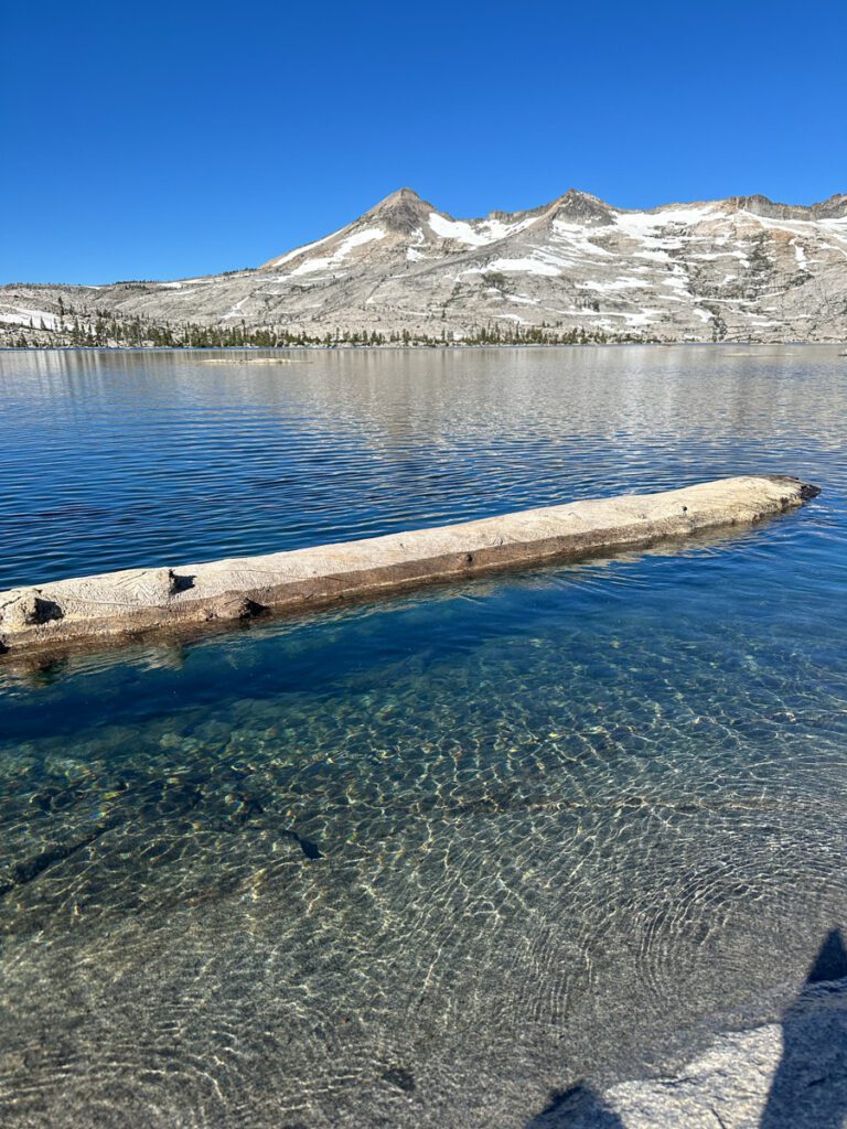 Lake Aloha featuring crystal clear waters and scenic views of snow-capped mountains.