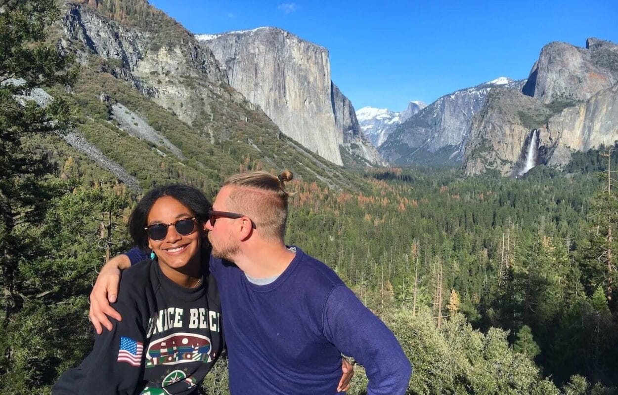 Couple sharing a kiss in front of El Capitan mountain