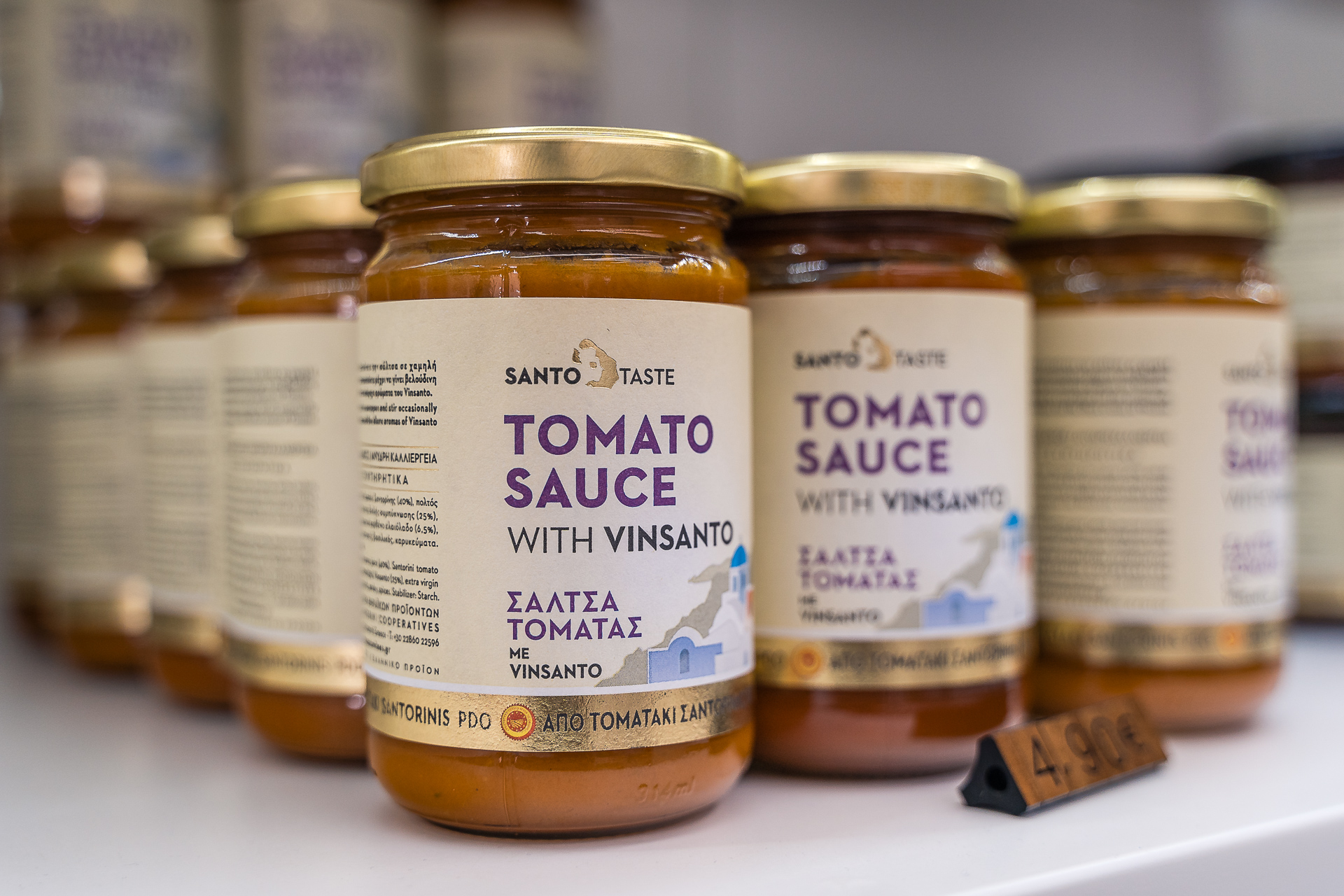 This image shows jars of Santorini tomato sauce with vinsanto wine.