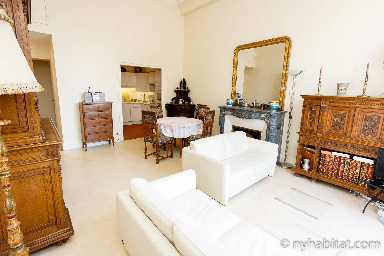 Living room of furnished apartment PA-3231 in Le Louvre, showing a door leading to the balcony at the back.