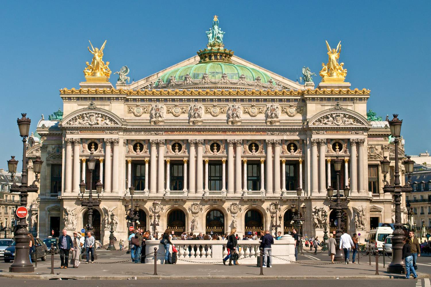 Place de l’Opéra in Paris, bustling with visitors in front of the majestic Neo-Baroque Garnier Palace.