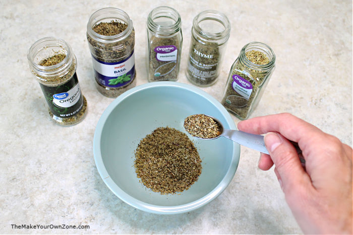 Measuring spices to make a DIY Italian Seasoning blend