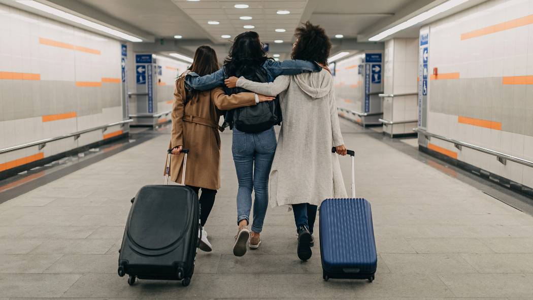 Three friends traveling with suitcases