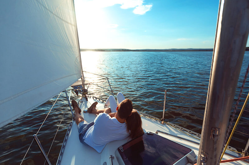 Couple snuggling on a sailboat in Maine