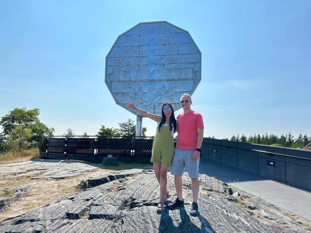 Taking a picture in front of the Big Nickel in Sudbury, Ontario.