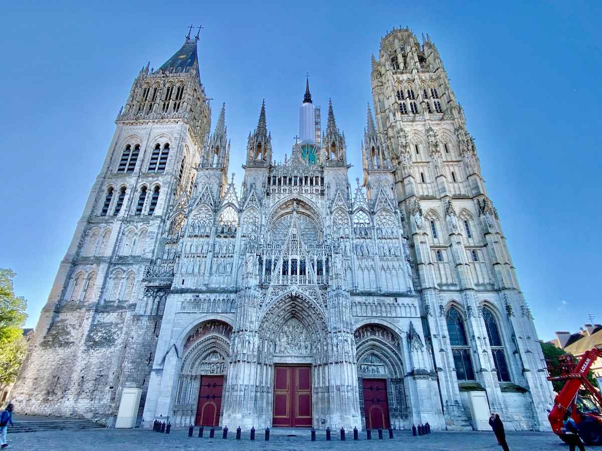 West facade of Rouen Cathedral against a blue sky