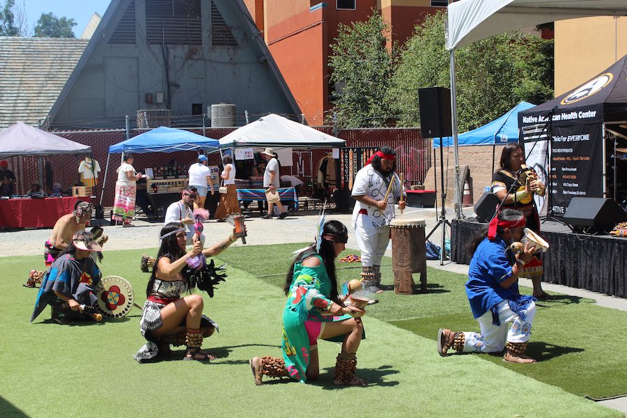 Kneeling dancers at Oakland, California's Indigenous Red Market.