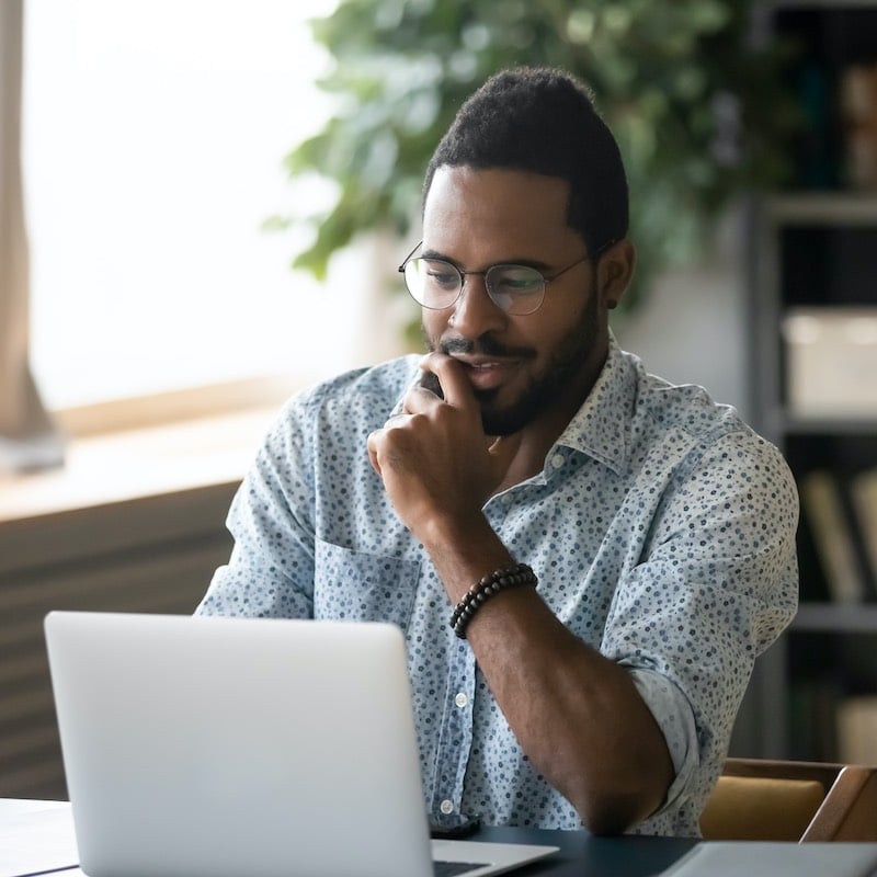 Smiling Young Man Using His Computer