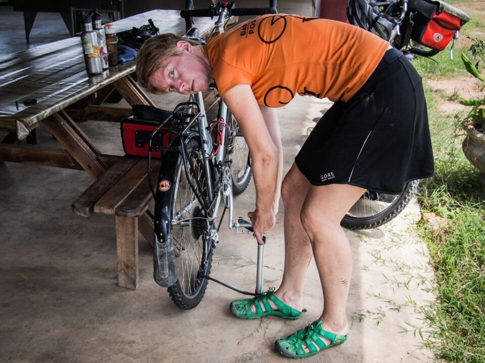 Jane fixing a flat tire in Malaysia