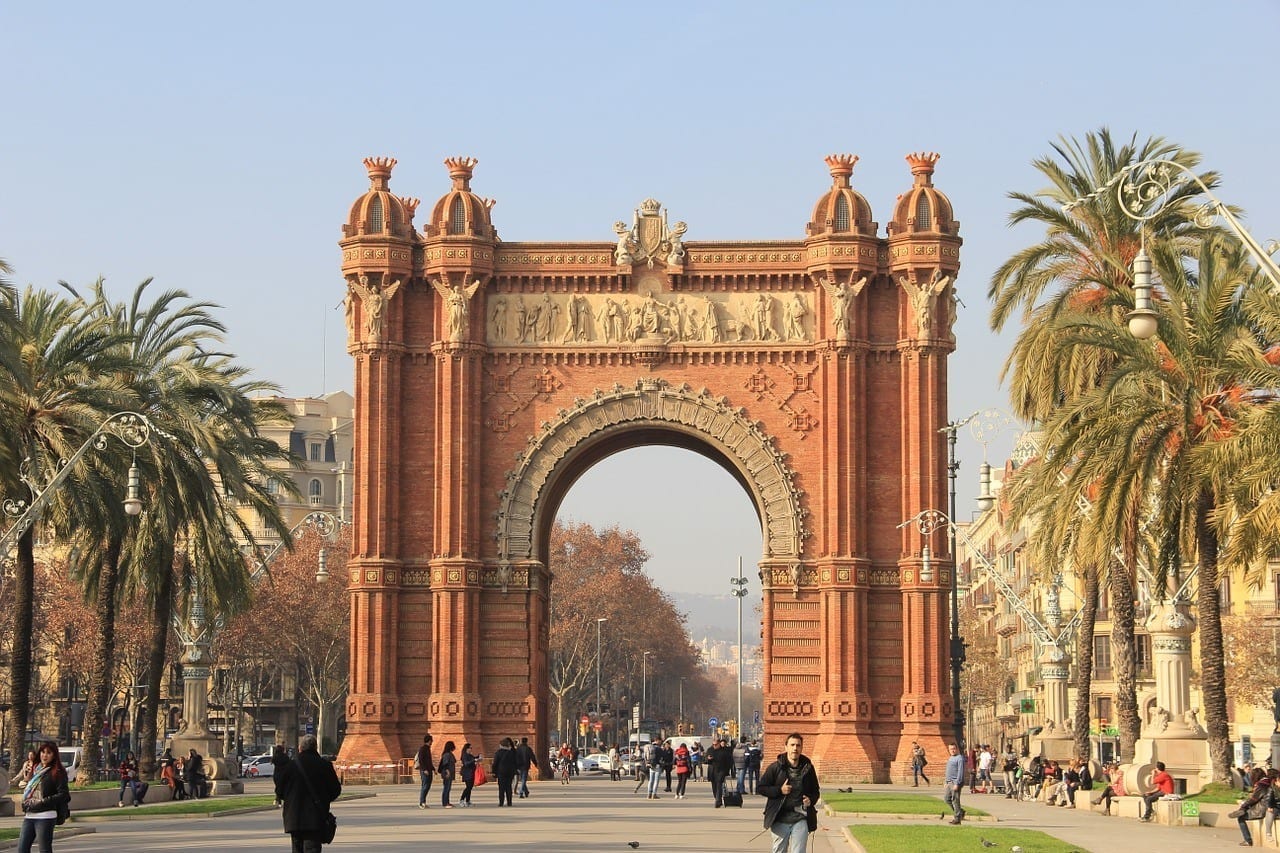 The Arc de Triomf in Barcelona, with palm trees lining its sides.